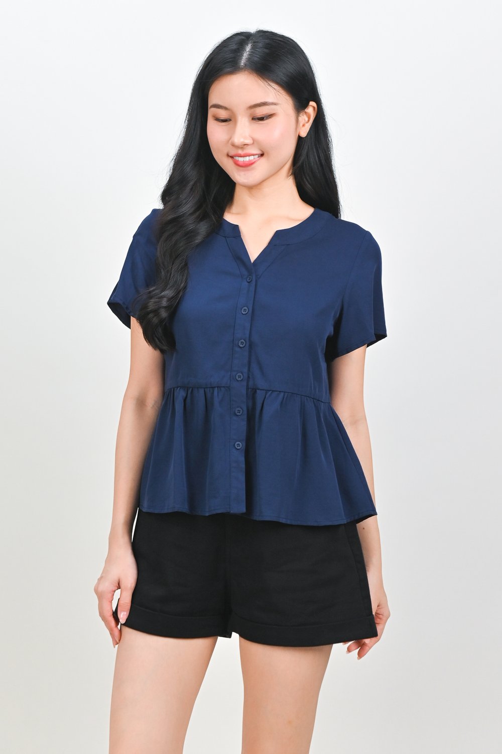NEMIRA NOTCHED-NECK PEPLUM TOP IN NAVY