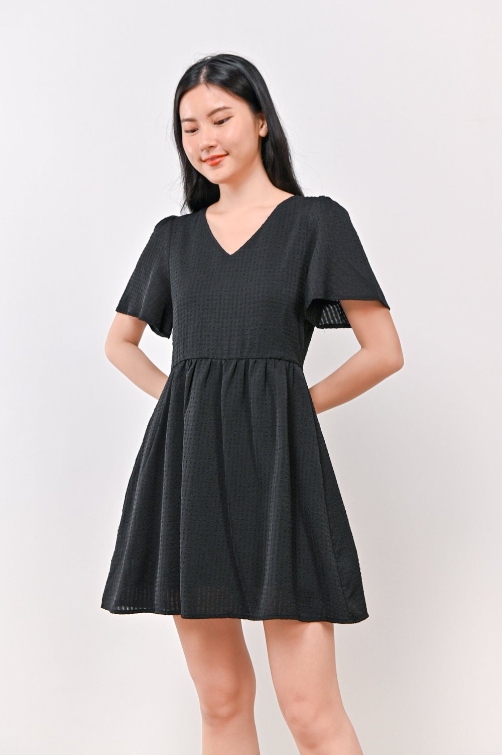 AMBER TEXTURED DRESS-ROMPER IN BLACK